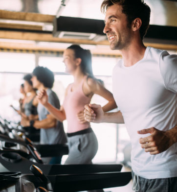 Happy group of sportive people in a gym. Concepts about lifestyle and sport in a fitness club